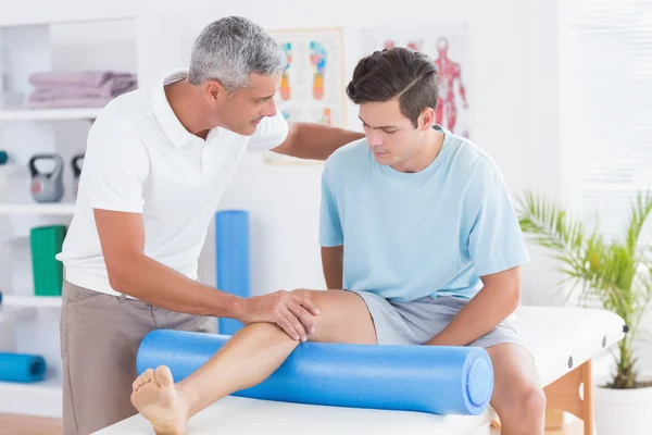 Doctor examining his patient leg 